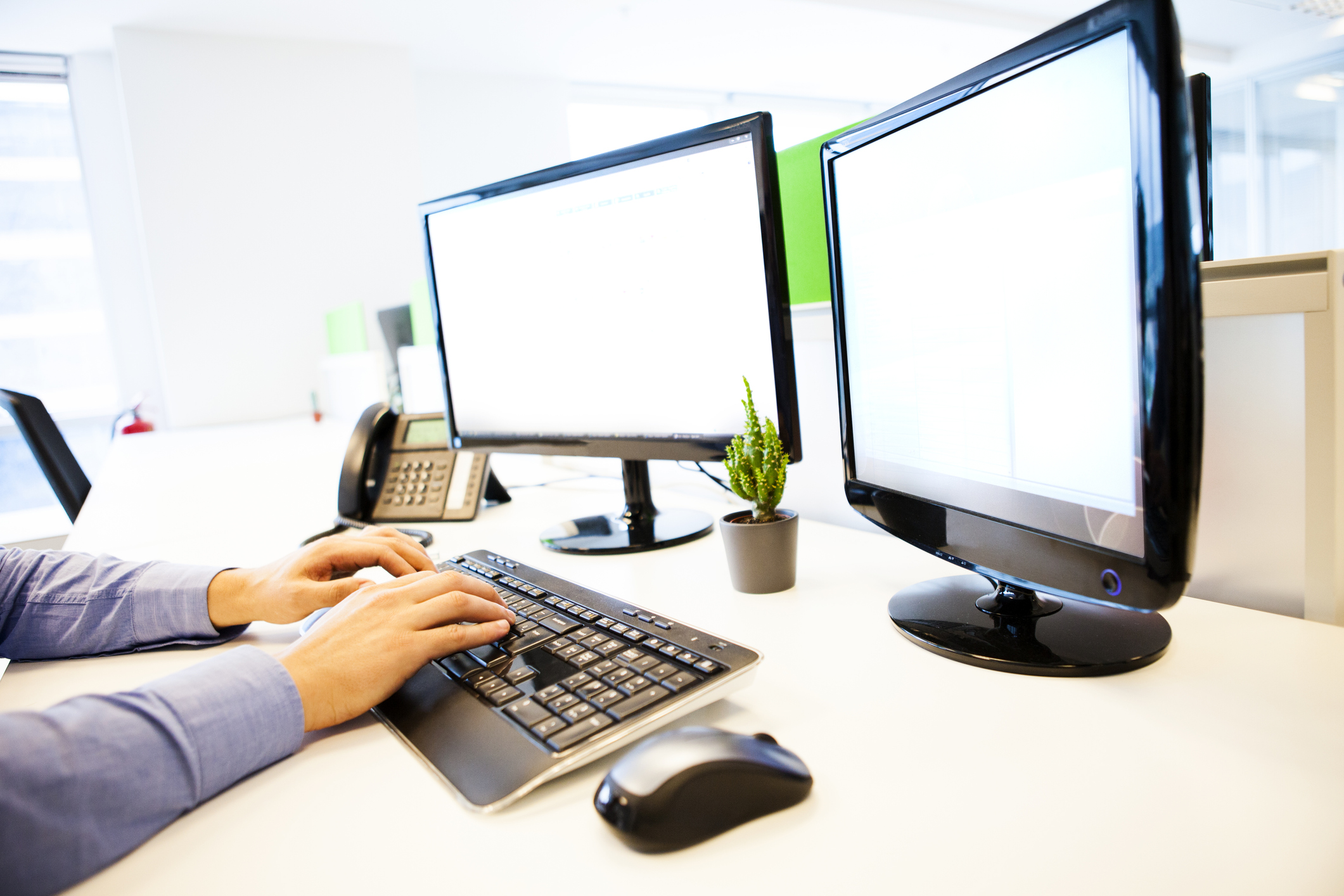 a woman navigates a web dashboard on her computer